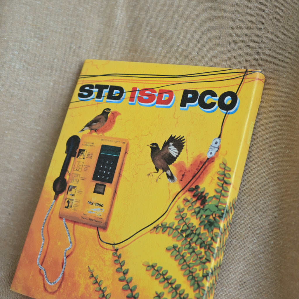 Singing mynas by a silent phone booth